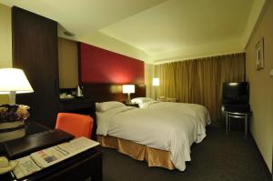 Ένα ή περισσότερα κρεβάτια σε δωμάτιο στο Delight Hotel