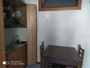 a kitchen with a wooden table and a sink at Casa Totano in Canneto +2 photos