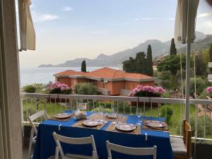 a dining table with a view of a house at Apartment Sillemi - Casa Sille in Letojanni