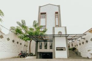 an image of a church with a building at Urbanest Inn House Slipi in Jakarta