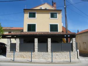 a building with windows in front of it at Apartment Mamut in Premantura