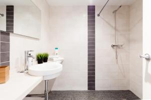 a bathroom with a sink and a shower at Sunset Boutique Duplex in Calonge +31 photos