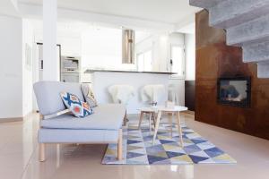 a living room with a chair and a table at Sunset Boutique Duplex in Calonge