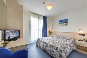Postel nebo postele na pokoji v ubytování Hotel Minerva