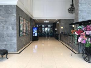 a hallway of a building with a lobby with flowers at Ashley Sabang Jakarta in Jakarta