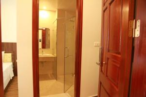 a bathroom with a glass shower and a sink at Khách sạn Hải Quân - The Marine Hotel in Ha Long +42 photos