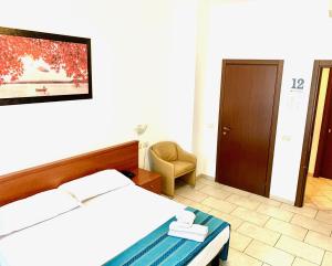 Posteľ alebo postele v izbe v ubytovaní Hotel Alessander