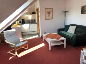 a living room with a couch and a table at Ferienwohnung LaMa in Wiendorf