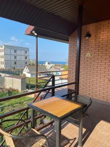 a table and chairs on a balcony with a view at Uytno in Chornomorsk