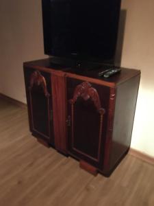 a wooden entertainment center with a television on top at Pousada Rancho Flores in Caeté