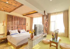 a bedroom with a large bed and a television at Old Story Inn Lijiang Old Town in Lijiang