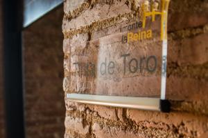 a brick wall with graffiti on it at Castillo de Monte la Reina Posada Rural & Bodega in Toro
