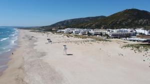 an aerial view of a sandy beach with houses at Hotel Avenida Playa in Zahara de los Atunes
