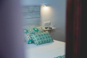 a bedroom with a bed with two pillows on it at Hotel Avenida Playa in Zahara de los Atunes