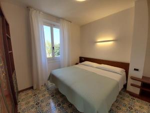 A bed or beds in a room at Residence L'Ulivo