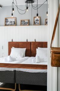 a bedroom with a large bed with white pillows at Hotell Furusund in Furusund