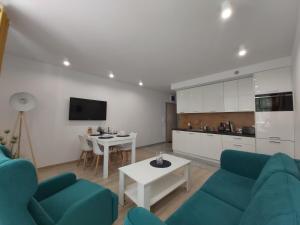 salon z kanapą i stołem w obiekcie Apartament Przy Lesie Słoneczne Tarasy w Dziwnówku