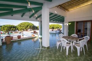 a dining room with a table and chairs on a patio at Agi Casa Puerto in Roses