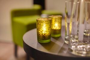three glasses sitting on top of a table at Bellevue-Terminus - Urban Lifestyle Hotel in Engelberg
