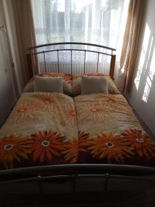 a bed sitting in a room with a window at Apartmán U Pavla in Broumov