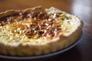 a pizza sitting on a plate on a table at La Fermette Champenoise in Jonquery