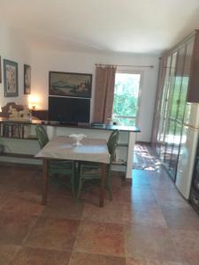 a living room with a table and a television at da lina in Porto Santo Stefano