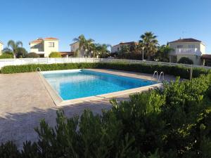 a swimming pool in the backyard of a house at Sunrise Villa in Perivolia