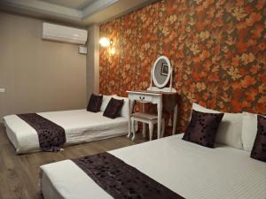 Postel nebo postele na pokoji v ubytování Guan Lun Hotel