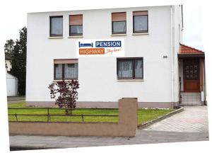 a white building with a sign in front of it at Pension Highway - Bünde Borriesstraße 39 in Bünde