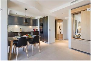 a kitchen and dining room with a table and chairs at Azur 3000 in Saint-Laurent-du-Var