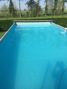 a large swimming pool with blue water at La Morinais in Éancé