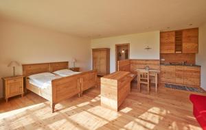 a bedroom with a bed and a desk in it at Weingut Stuck in Appiano sulla Strada del Vino