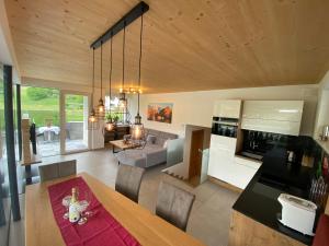 a kitchen and living room with a table and chairs at Appartementhaus Anna in Leogang