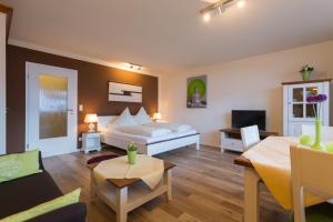 a bedroom with a bed and a living room at Ferienwohnung Boland in Oberstdorf