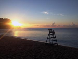 a lifeguard tower on the beach at sunset at Apartaments Condado by Marsol in Lloret de Mar