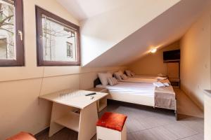 a small room with a bed and a desk at Denicia Apartments in Ohrid