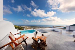 a balcony with a view of the ocean on a house at San Martino cave villas in Pyrgos