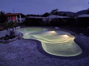 una piccola piscina in un cortile di notte di Iacovino Country House a Sarzana