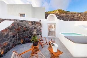a patio with chairs and a swimming pool at San Martino cave villas in Pyrgos