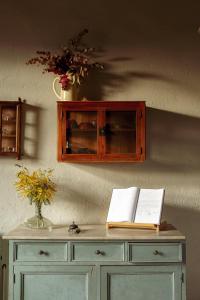 a cabinet with two books on top of a table at Masia CasaJoana Rural in Rellinars