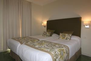 سرير أو أسرّة في غرفة في Villa Mar Azul Suite