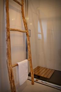 a shower with a wooden frame and a towel in a bathroom at Casa da Fonte Limpa in Mirandela