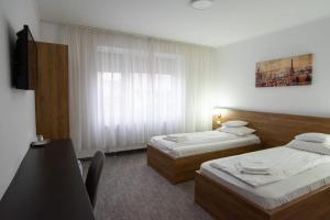 Postel nebo postele na pokoji v ubytování Carnival City Hotel Oradea