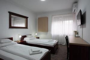 Postel nebo postele na pokoji v ubytování Carnival City Hotel Oradea