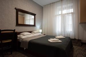 Postel nebo postele na pokoji v ubytování Carnival City Hotel Oradea