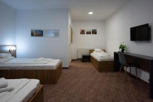 Postel nebo postele na pokoji v ubytování Carnival City Hotel Oradea