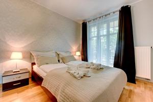 a bedroom with two beds with towels on them at Bianca Apartments by Renters in Sopot