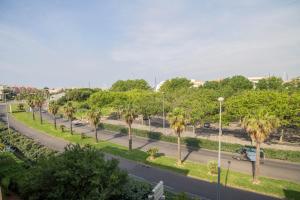 a street with palm trees on the side of a road at Appartement les Falaises in Cap d'Agde