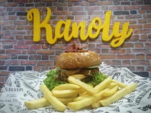 a hamburger and french fries on a plate with the word laundry at Hotel Prado Country in Aguachica
