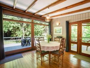 a dining room with a table and chairs at Cozy Chalet in Trois Ponts with Forest Near in Trois-Ponts